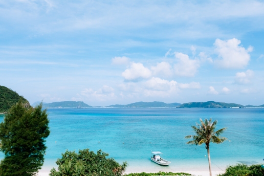 Hotel room view of tropical beach and coconut palm tree, Okinawa, Japan