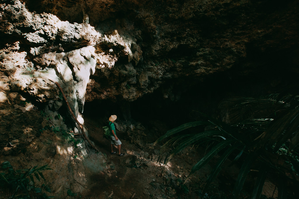 Exploring a limestone cave in jungle of Iriomote Island, Japan